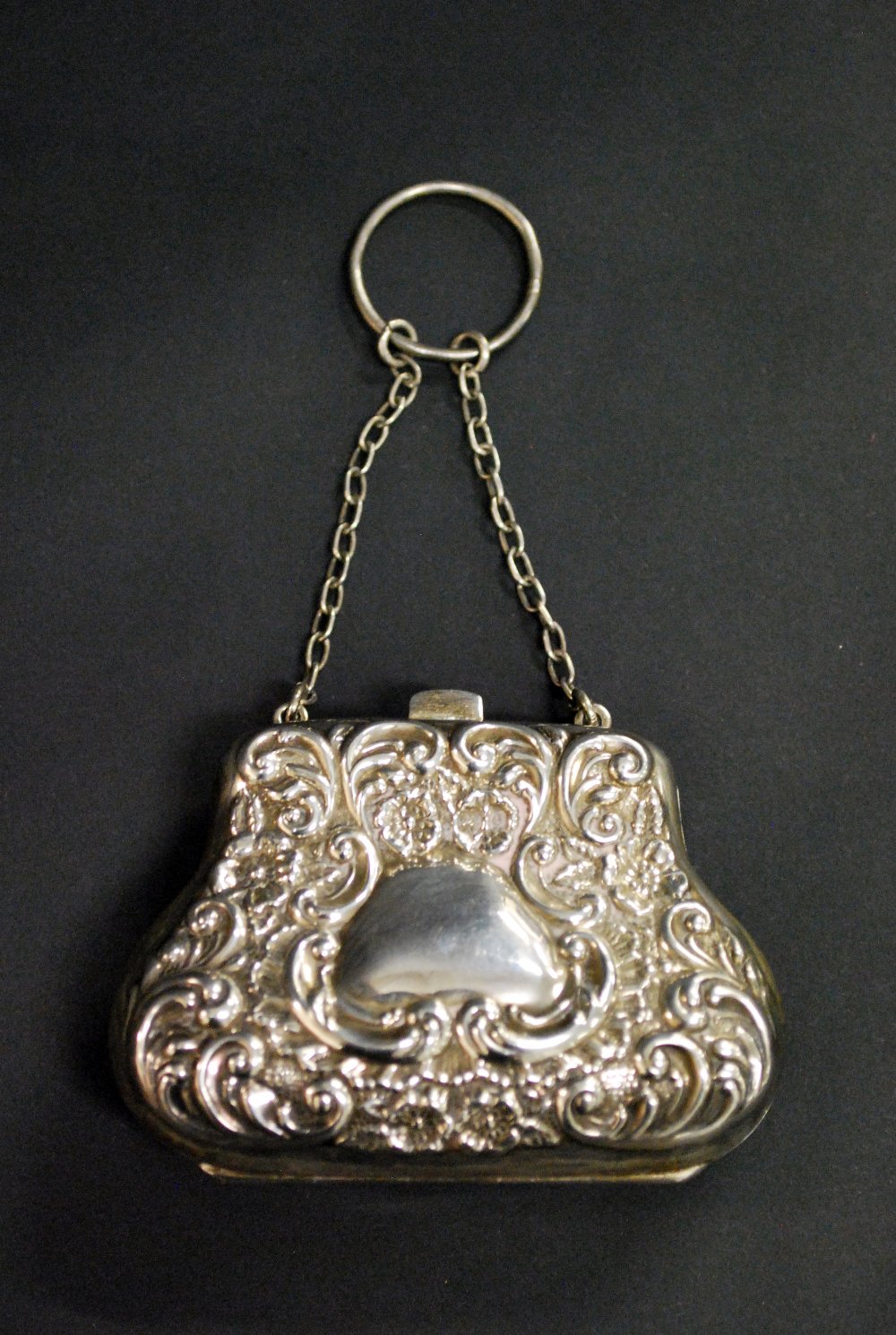 Hallmarked silver repousse decorated fitted purse.