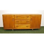 An Ercol Windsor Blonde sideboard of drawers and cupboards