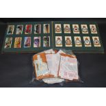 A collection of cigarette and trade cards.