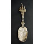 A hallmarked silver relief decorated spoon with the handle terminating in a galleon.