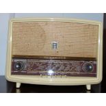 A cream coloured vintage radio.