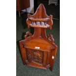 An oak continental miniature carved fronted corner cupboard.