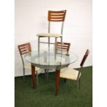 A contemporary circular dining table with four chairs