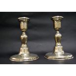 A pair of .833 silver candlesticks.