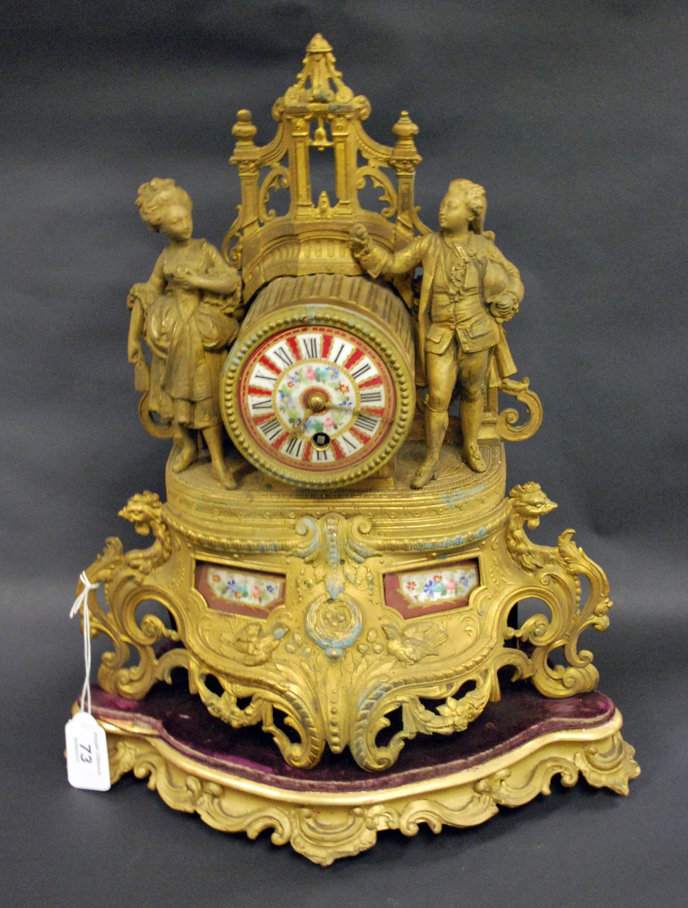 A 19th Century gilt metal French table clock with painted porcelain dial on a gilt stand to accord.