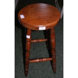 A 20th Century pine kitchen stool on turned supports.