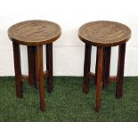 A pair of highly carved continental circular topped folding occasional tables.