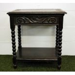 A Victorian carved oak side table raised on bobbin supports with an under-shelf