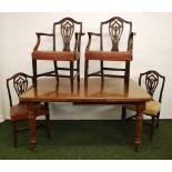 A mahogany wind-out extending dining table with an extra leaf together with a set of six pierced