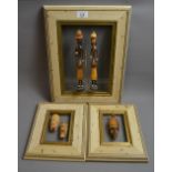 Three African art pieces in frames. Larg