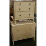 A white chest of three drawers and a whi