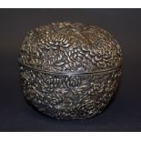 A Japanese silver circular pot with cover, relief decorated with chrysanthemums,