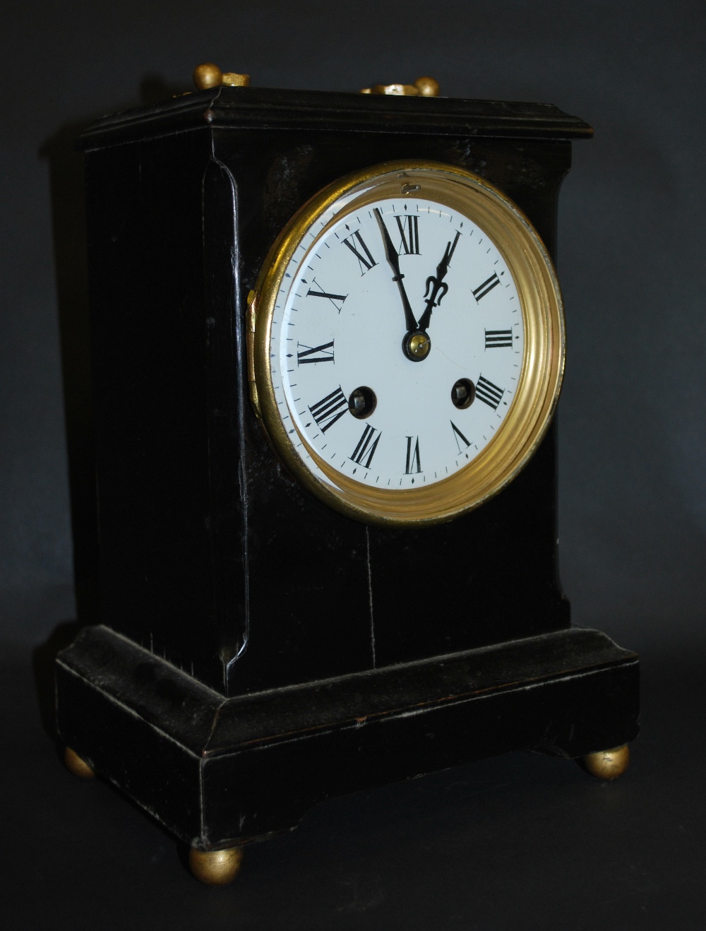 An ebonised French bracket clock having a circular enamelled dial with Roman chapters. - Image 2 of 3