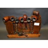 An oak pipe rack with a selection of 10 vintage pipes manufactured by Dunhill, Barling, Weingott,