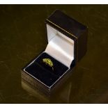 A 9 ct gold ring (Size Q) set with three Peridot