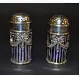 A pair of hallmarked silver pepperettes,