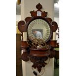 A wall hanging mahogany-framed mirror with electric-candle light fittings