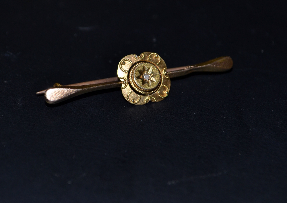 A 15 ct bar brooch set with an old cut diamond