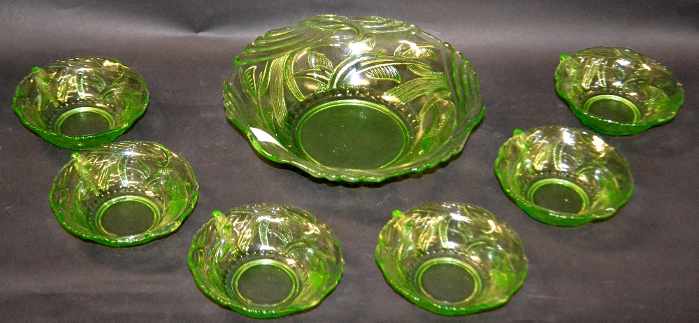 A mid 20th century green-tint punch set, relief decorated,