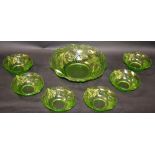 A mid 20th century green-tint punch set, relief decorated,