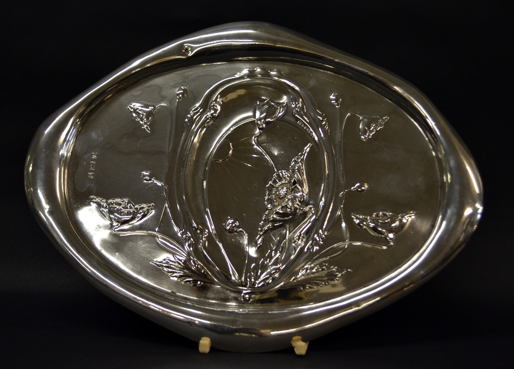 A hallmarked silver art nouveau tray, relief decoration of flora, with a raised lobed edge.