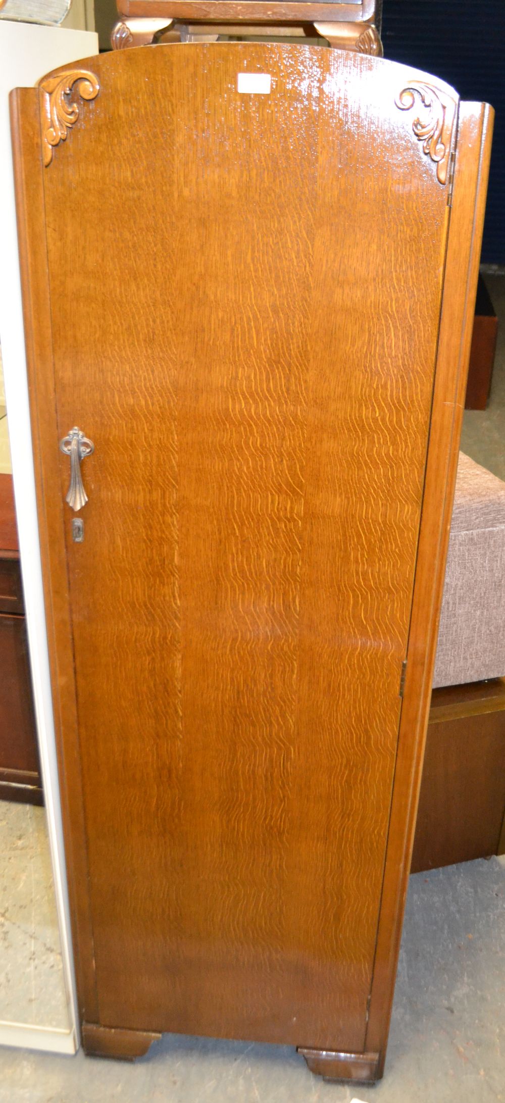 An oak single-door wardrobe and a mahoga