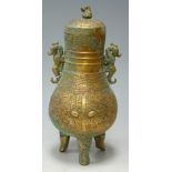 An Eastern bronze jar and cover with dragon mask handles and incised decoration