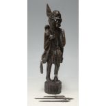 A modern carved softwood figure of a tribal warrior