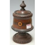 A 19th century carved walnut pedestal tobacco jar and cover having lead lined interior