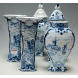 A set of three Dutch Delft porcelain blue & white jars and covers (one lacking cover) together with