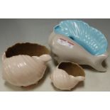 Two 1960s Poole Pottery two-tone conch shaped shell vases;