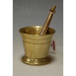 A 19th century turned brass pestle and mortar