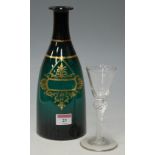 A 19th century green glass and gilt decorated spirit decanter lacking stopper,