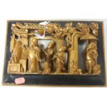 A Chinese carved softwood and gilt painted figural wall plaque