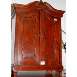 A late 19th century continental apprentice piece armoire enclosed by a pair of panelled doors on