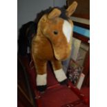 A childs rocking horse with tack