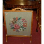 A walnut topped stained beechwood demi-lune hall table and an oak framed woolwork inset fire screen