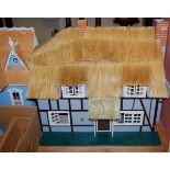 A two storey blue painted dolls house in the New England style together with a 17th century style