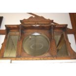 A circa 1900 carved oak and copper inset overmantel mirror,