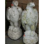 A pair of white painted reconstituted stone garden eagles