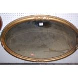 A late 19th century giltwood beaded oval bevelled wall mirror