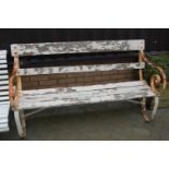 A 19th century white painted wrought metal framed and slatted three-seater garden bench