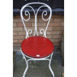 A Victorian white painted wrought metal single garden chair with replacement stained pine seat