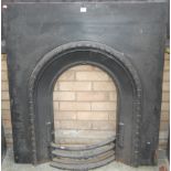 An Edwardian cast iron black painted fire surround