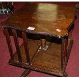 An early 20th century beech table top revolving bookcase