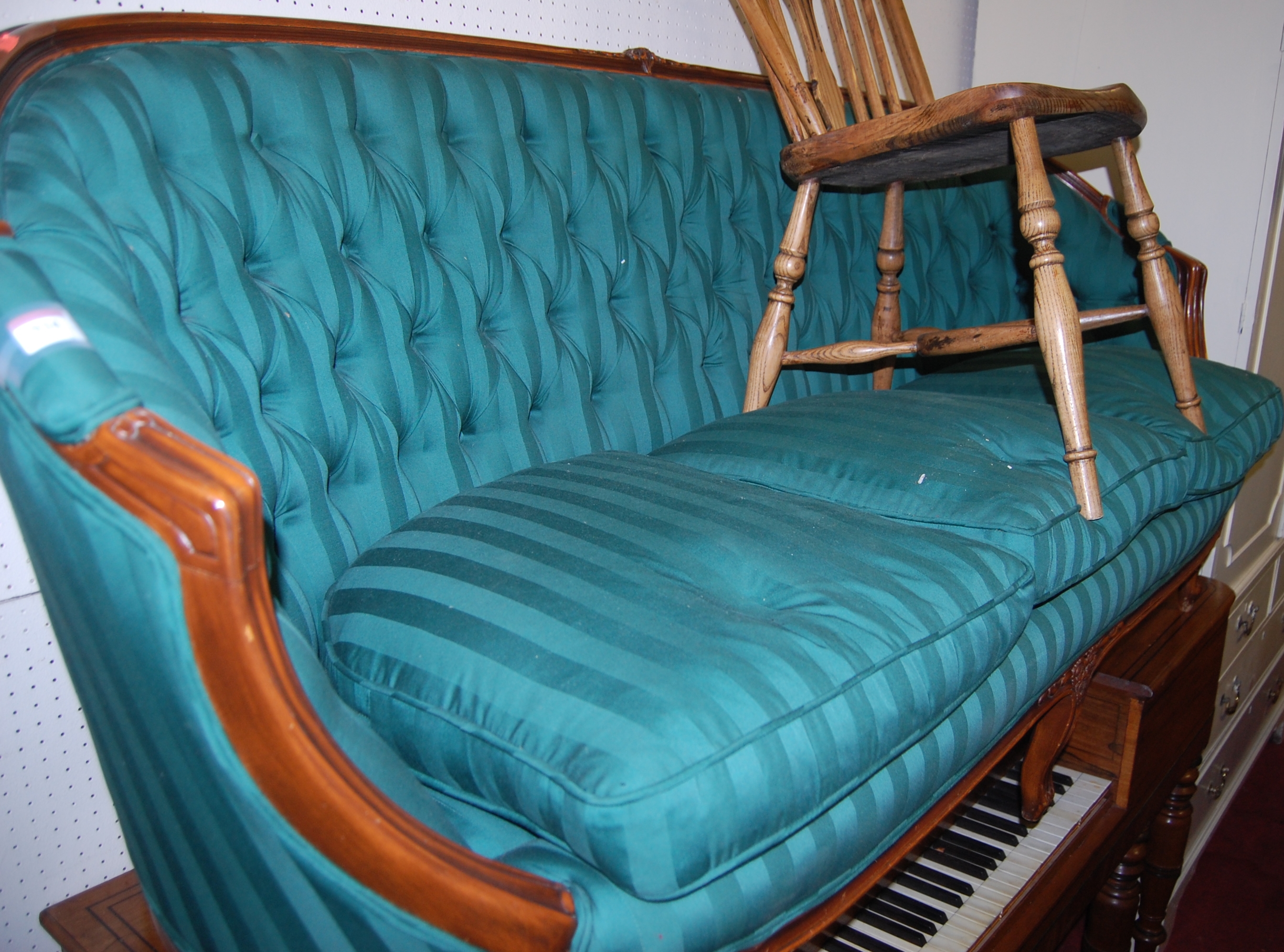 A Louis XV style green striped upholstered button back three seater canape
