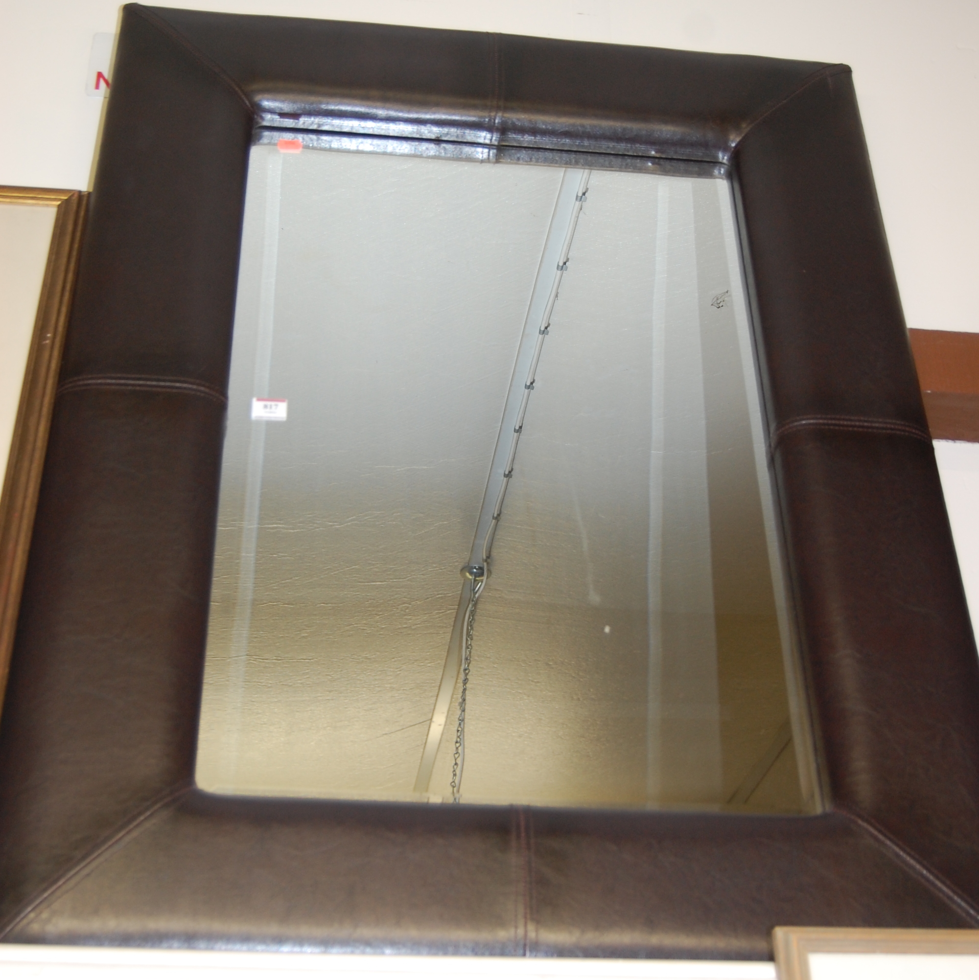 A modern leather framed wall mirror,