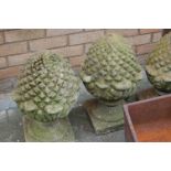 A set of five reconstituted stone garden pineapple finials