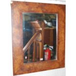 A modern rectangular framed wall mirror