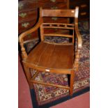 A 19th century provincial East Anglian elm panelled seat elbow chair,